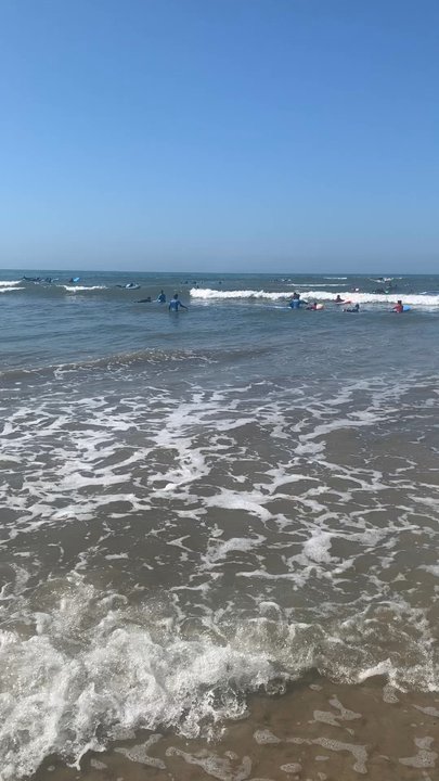 Ohana Surf Camp - Instructor Sam giving high five encouragement after a nice run - Summer Camps Near Me - Ventura, California