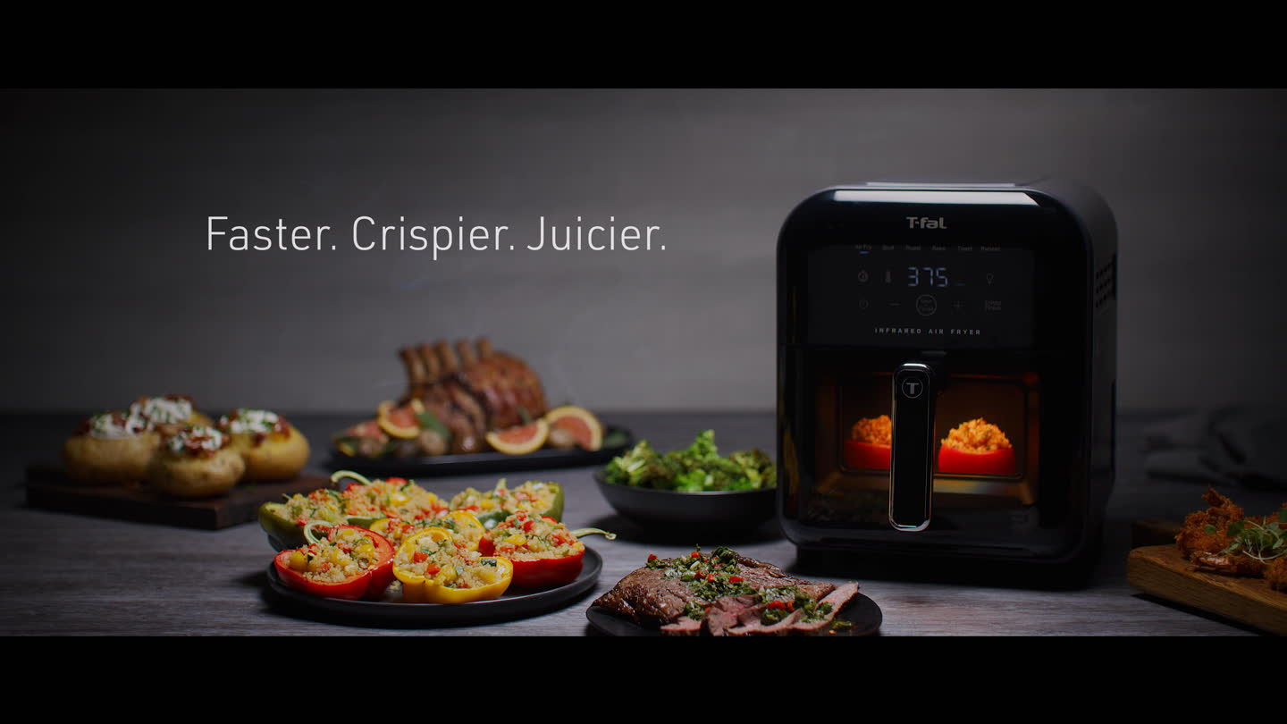 Film still: the air fryer surrounded by prepared dishes
