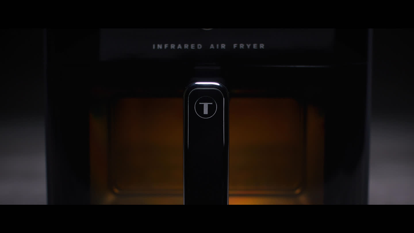 Film still: a close view of the air fryer handle and viewing window