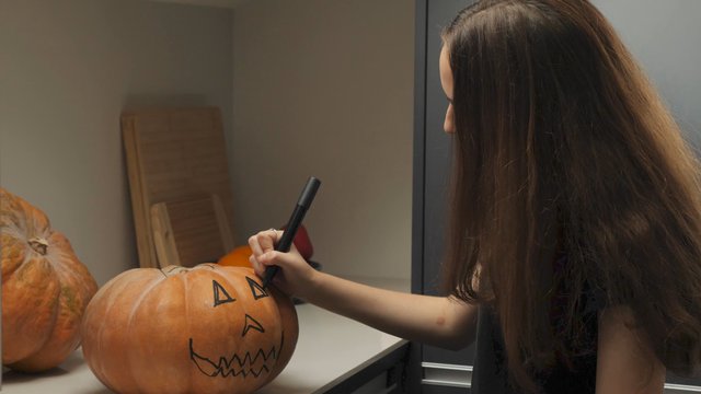 Drawing eyes on a pumpkin