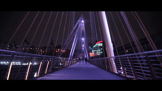 Walking across a bridge at night