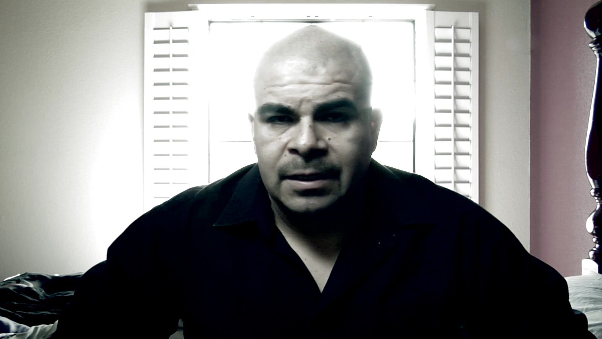 A man speaks directly to the camera in an intimate, indoor setting, followed by a brief scene of an individual wearing a backpack and face mask. The sequence captures a candid and introspective communication moment.