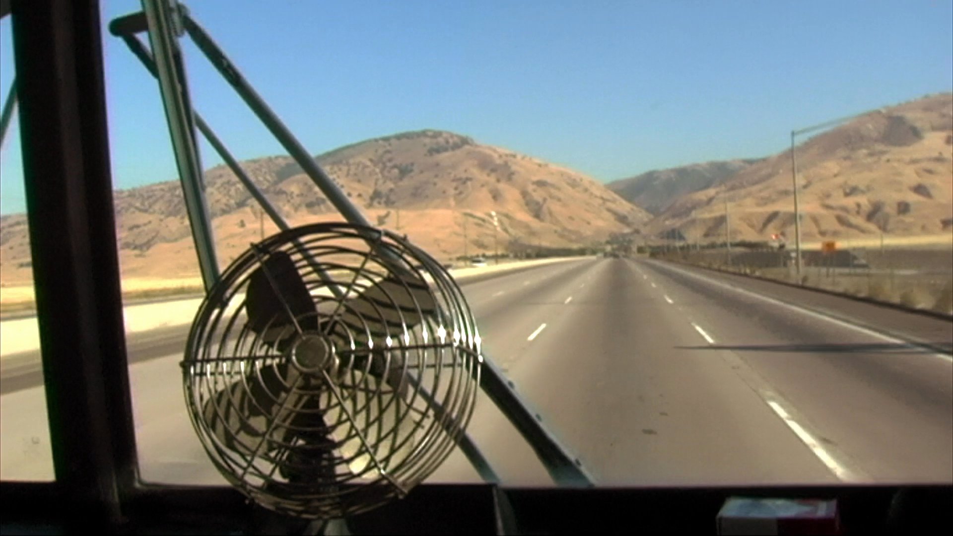 Steve Schapiro, a motorcycle attorney, discusses his professional background and advocacy for riders while traveling by road. The footage captures both his transit and interview segments in diverse environments.