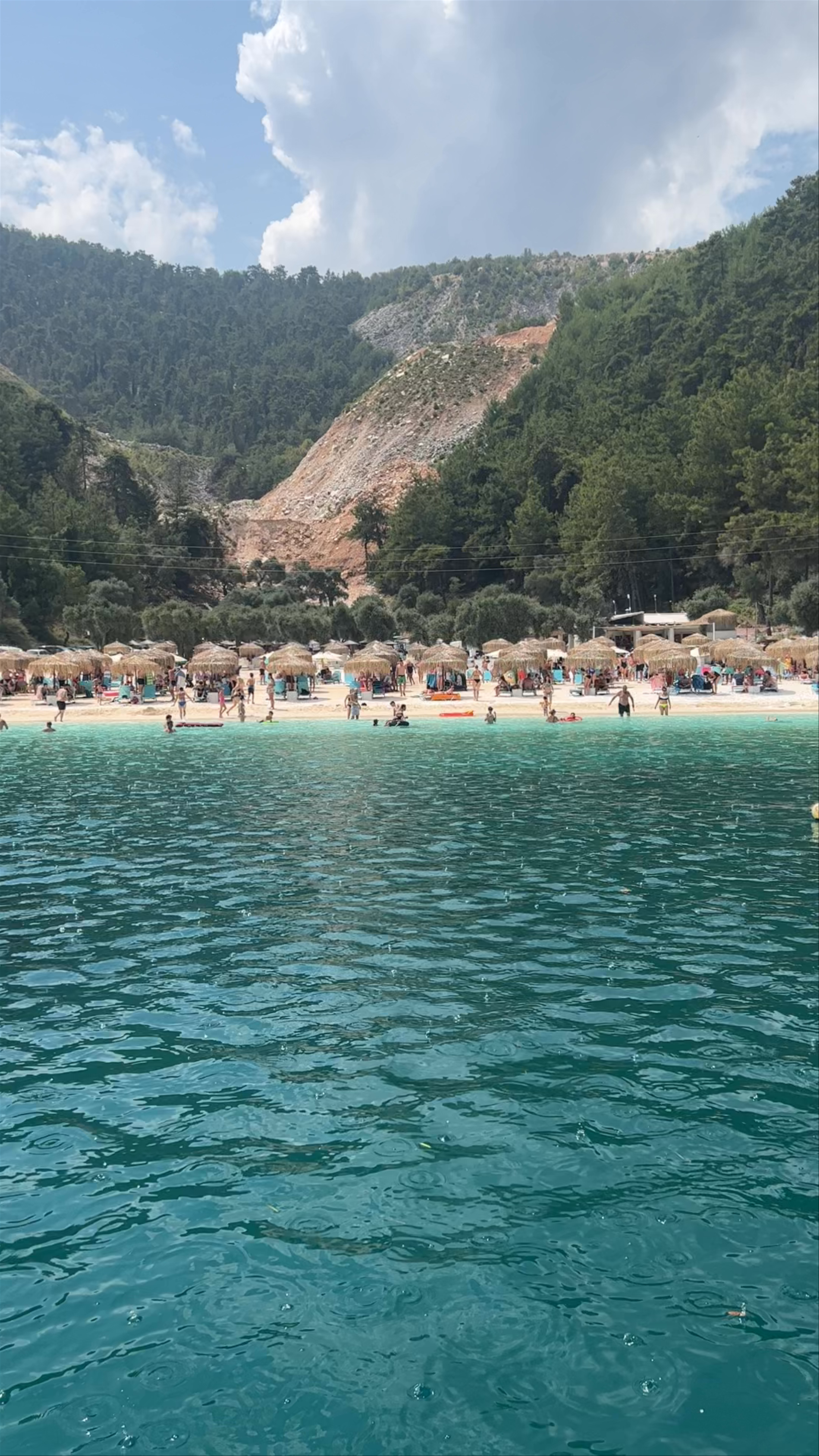 Marble Beach Bliss: Crystal Waters and Lush Green Hills on Thasos Island