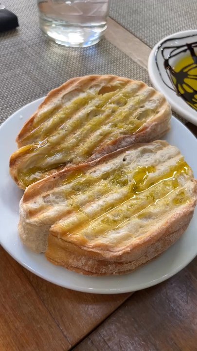 Caprice Cafe - Bread and some balsamic vinegar to start. She even did the balsamic vinegar spooky style for Halloween lol - New American Near Me - Redlands, California