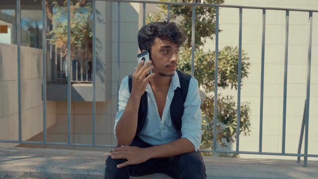 A teenage boy talking on his mobile phone