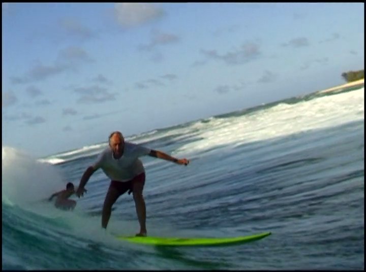 An experienced surfer discusses the evolution of the sport while showcasing modern and vintage footage of riders navigating large waves.