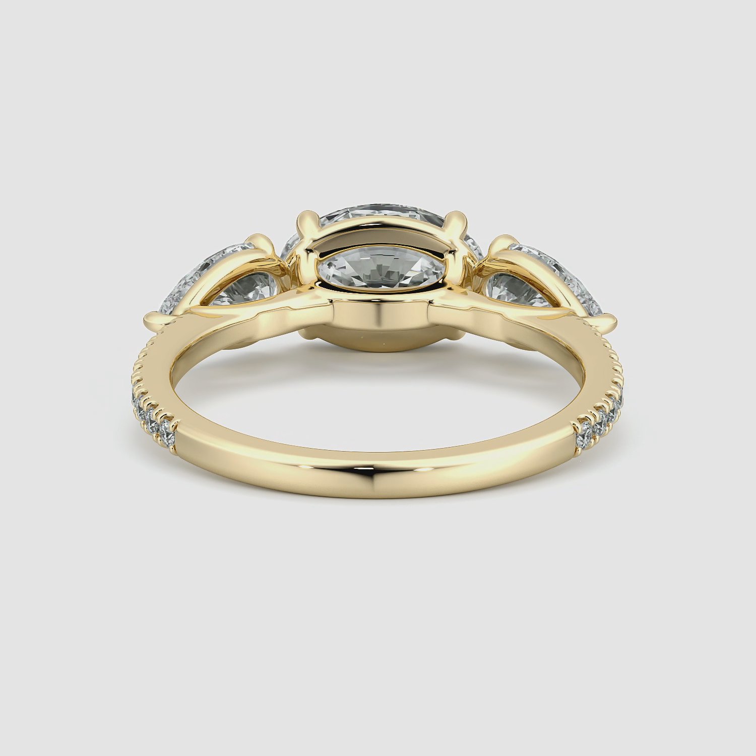 The Three Stone | Oval | 18k | Yellow Gold | bandAccent: Pavé | diamondOrientation: horizontal | sideStoneCarat: 0.50ct | sideStoneShape: Pear | caratWeight: other
