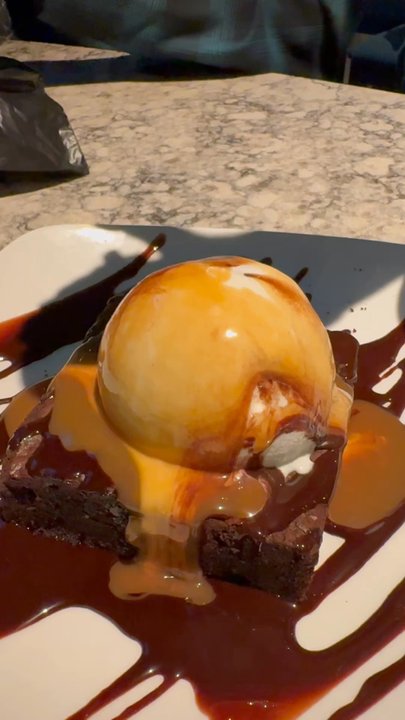 Firebirds Wood Fired Grill - Chocolate brownie with the caramel sauce- feeling the drizzle - American Near Me - Surprise, Arizona