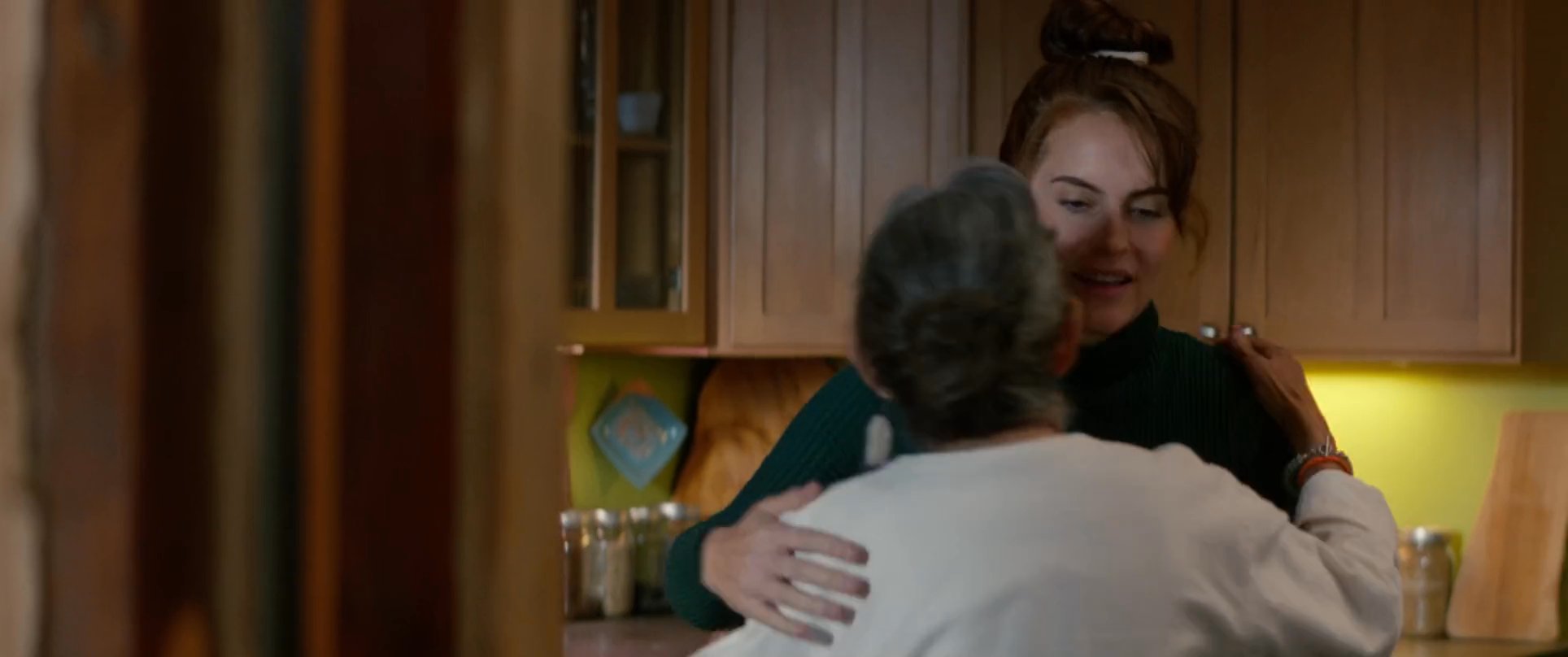 A care professional offers comfort and assistance to an elderly woman during a difficult time in her home.