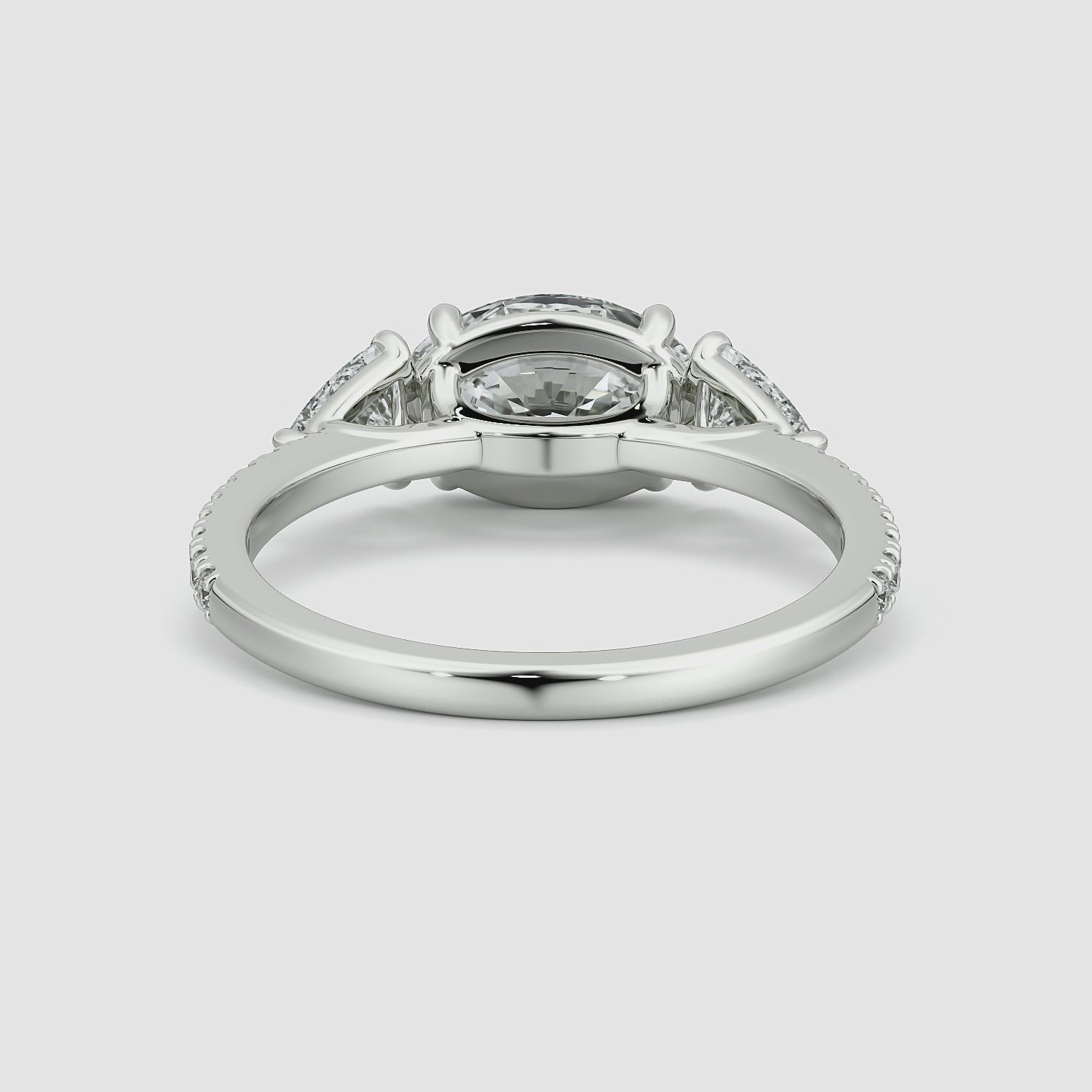 The Three Stone | Oval | 18k | White Gold | bandAccent: Pavé | diamondOrientation: horizontal | sideStoneCarat: 0.25ct | sideStoneShape: Trillion | caratWeight: other
