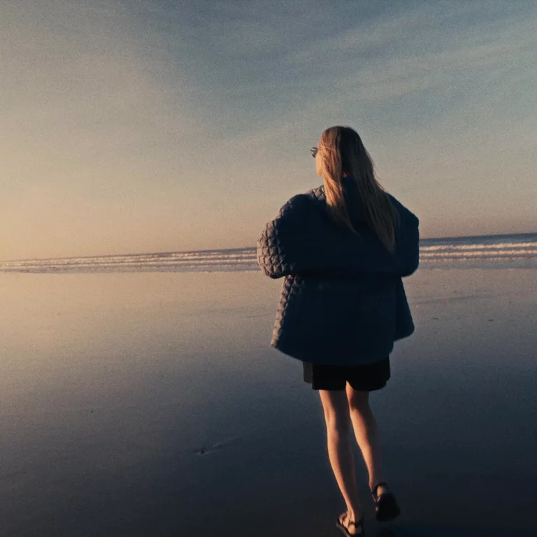Video of woman walking on the wet beach at sunset in Morocco