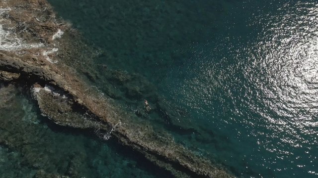 A man swimming near to the mid-ocean ridge