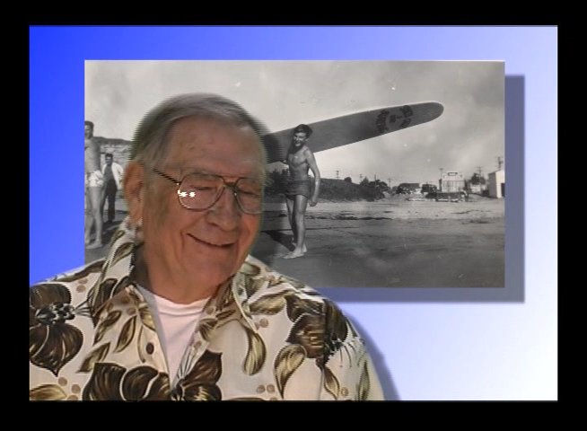 An elderly veteran shares historical accounts of aviation and surfing in a reflective interview setting. The narrative transitions between personal anecdotes against a backdrop of archival imagery and present-day reflections.