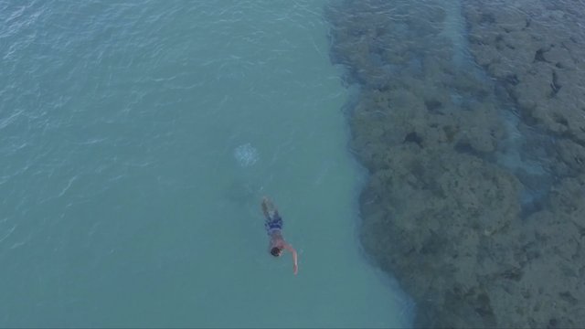 Man swimming near a coral reef