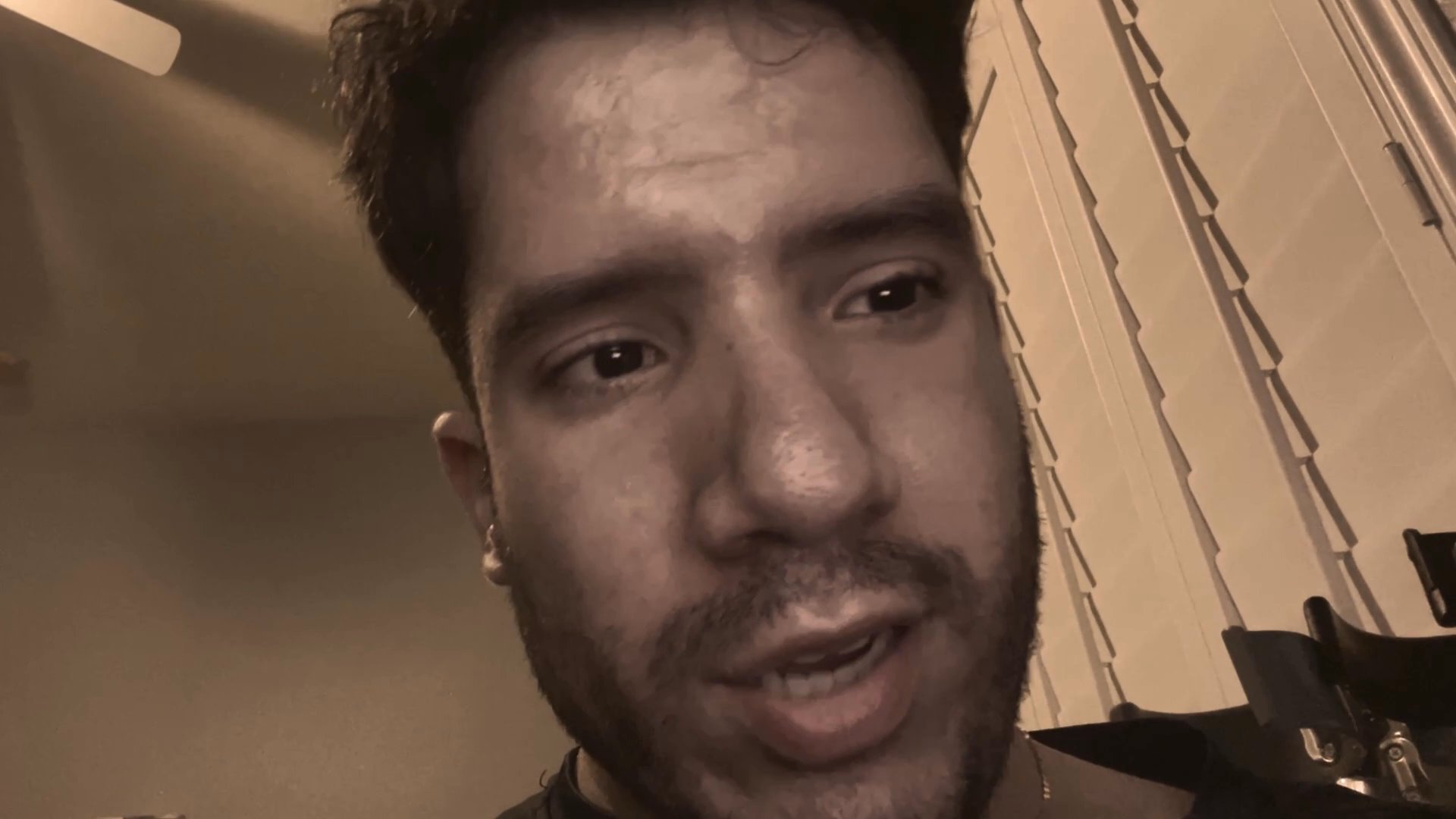 A man addresses the camera in a close-up monologue before shifting to a woman who shares her perspective in a conversational exchange.