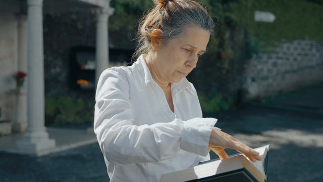 A woman turning pages in a Holy Bible