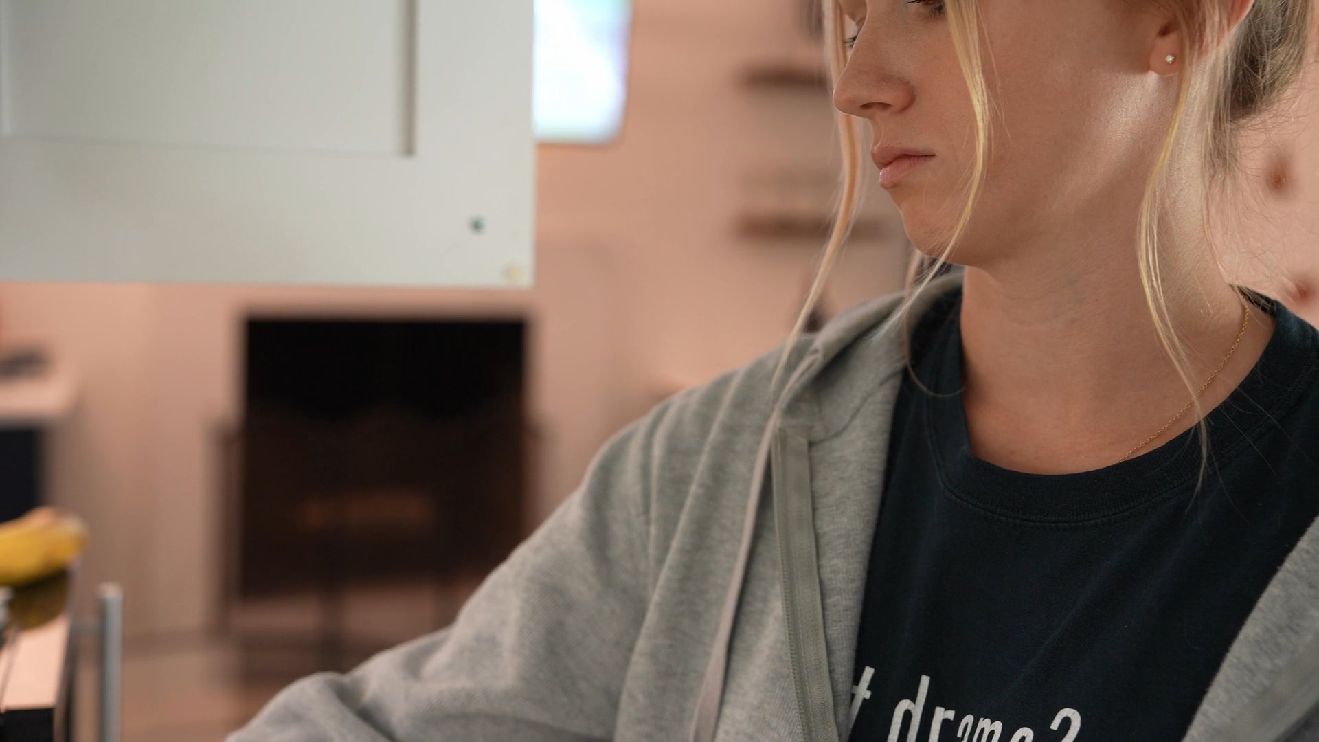 A woman engages in her morning kitchen routine, focusing on preparing coffee in a modern residential interior. The sequence transitions between outdoor activity and indoor beverage preparation.