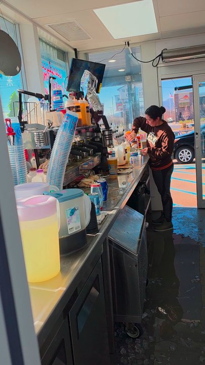 7 Brew Coffee - The friendly and efficient baristas preparing the orders and customers line up in their cars to receive them. - Coffee & Tea Near Me - Salem, Virginia