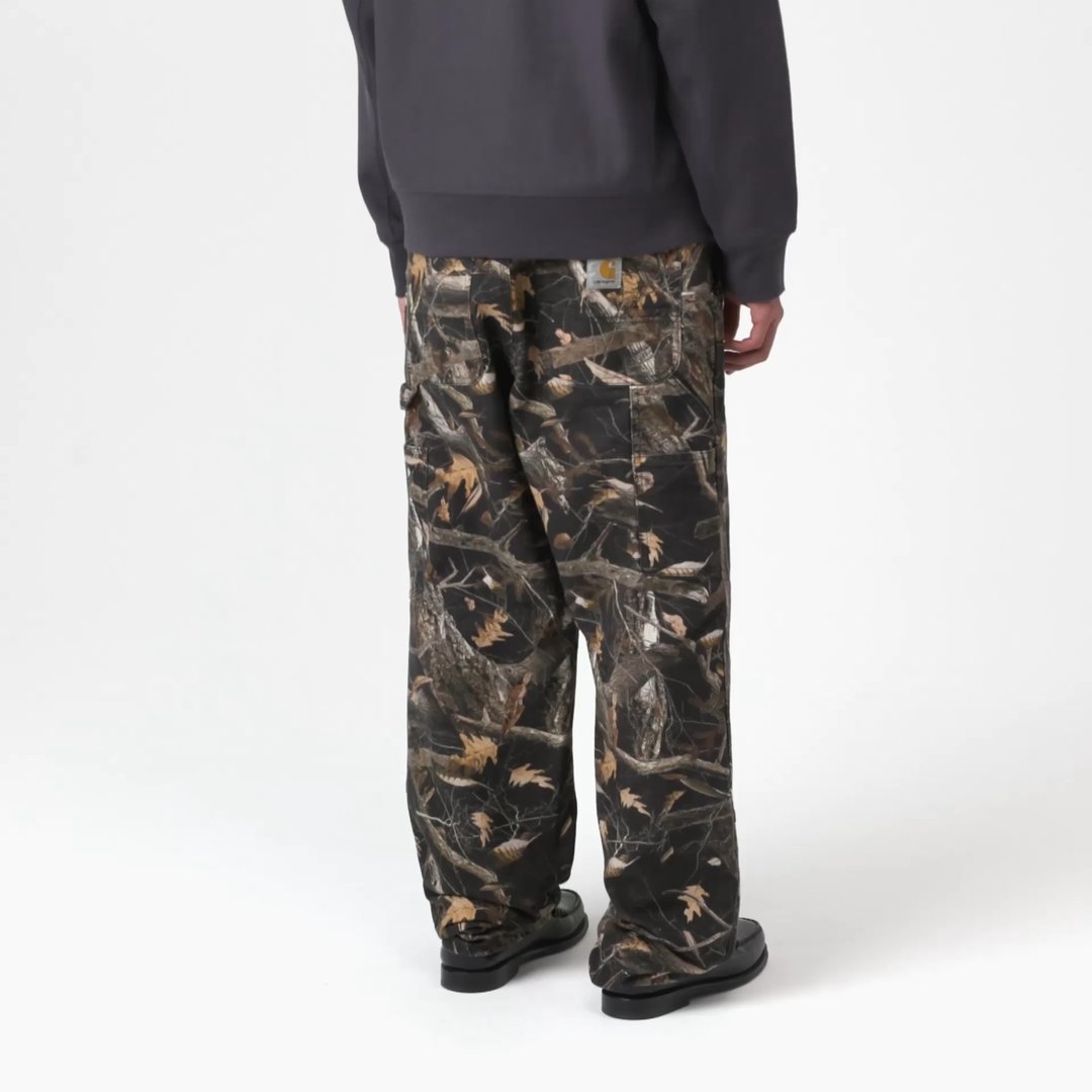 Model wearing a Double Knee Pant in Camo Feather Tree