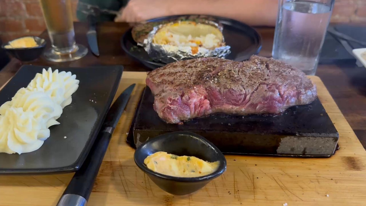 R Place Stone Grill - Texas Ribeye on a hot stone with bourbon sauce and a side of mashed potatoes - Seafood Near Me - Van Wert, Ohio