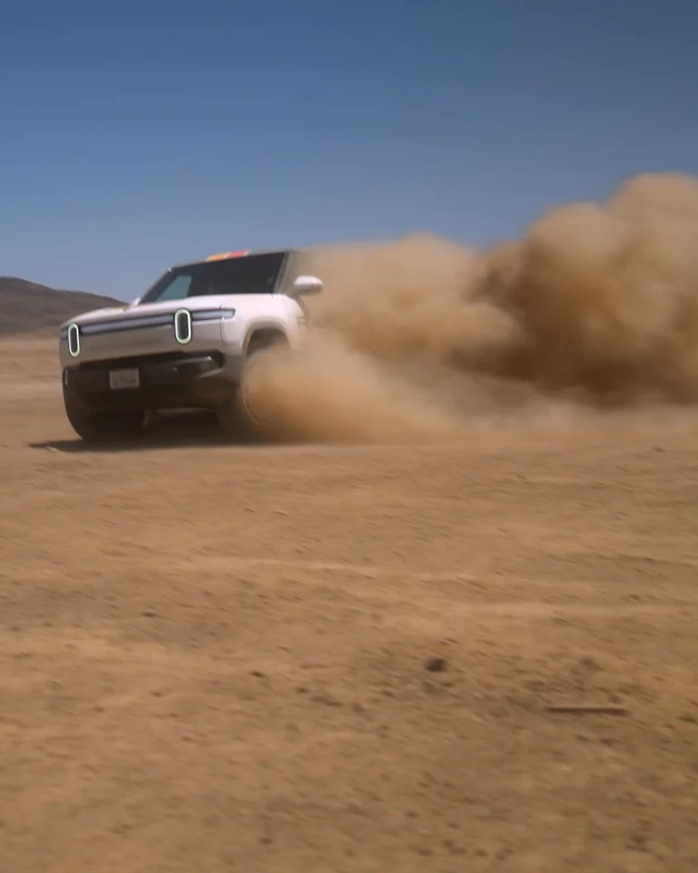 Video of Rivian drifting in desert landscape kicking up large plumes of dirt
