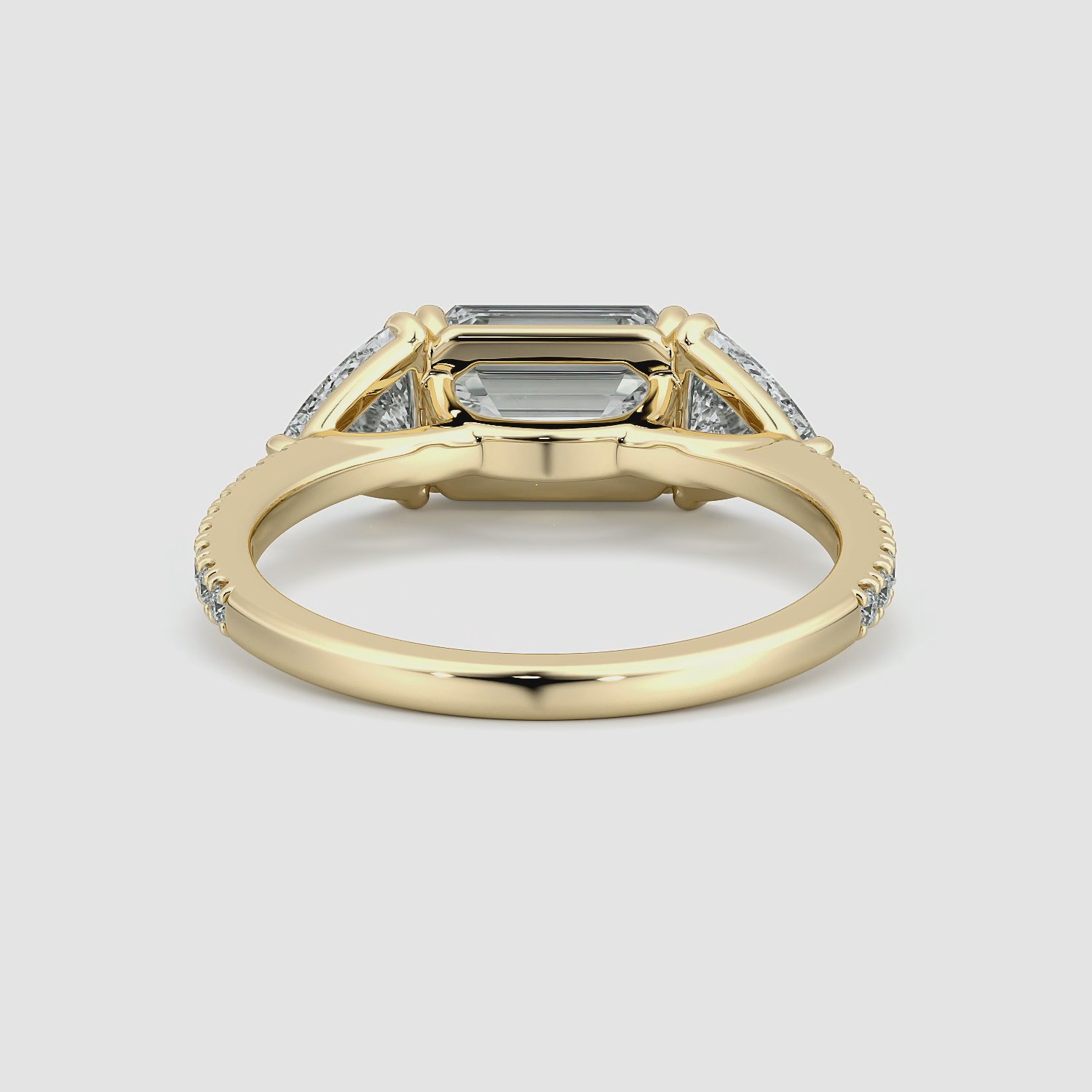 The Three Stone | Emerald | 18k | Yellow Gold | bandAccent: Pavé | diamondOrientation: horizontal | sideStoneCarat: 0.50ct | sideStoneShape: Trillion | caratWeight: other