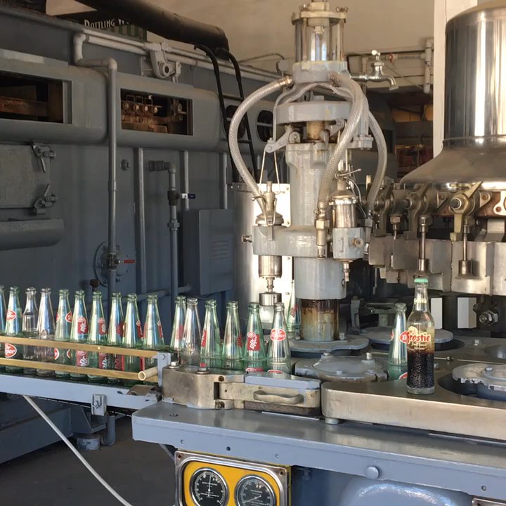 Dublin Dr Pepper Museum - Bottling Machine - first the syrup is added, then the carbonated water, and finally the cap. - Specialty Food Near Me - Dublin, Texas