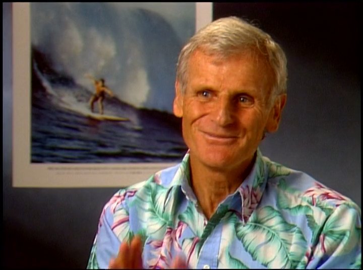 Two veteran figures in the surfing community share their insights and personal history through a series of interview segments. The discussion highlights the technical and cultural evolution of the sport against a backdrop of iconic surf imagery.