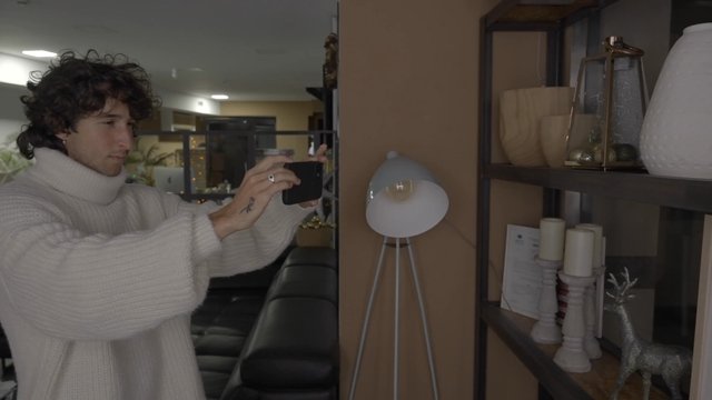 A man taking photos of Christmas decorations in his office