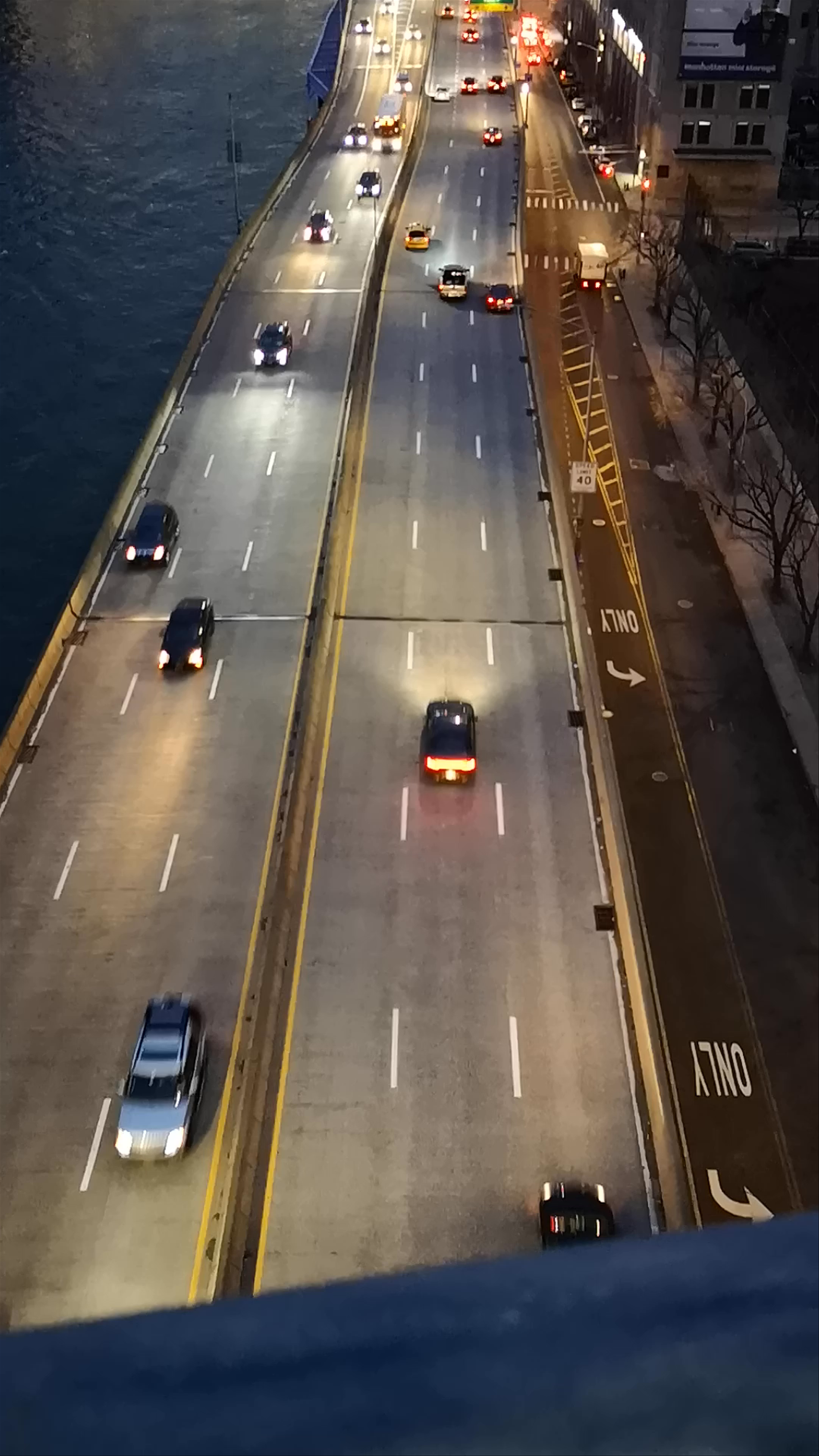 Manhattan Bridge Twilight Drive and NYC Skyline at Dusk