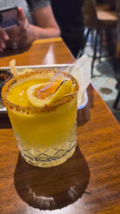 The Flying Mexican - This drink is called the sweet chin music, it comes out wit the mango lit on  fire.  It was spicy and pretty good tho! - Mexican Near Me - Washington, DC, District of Columbia