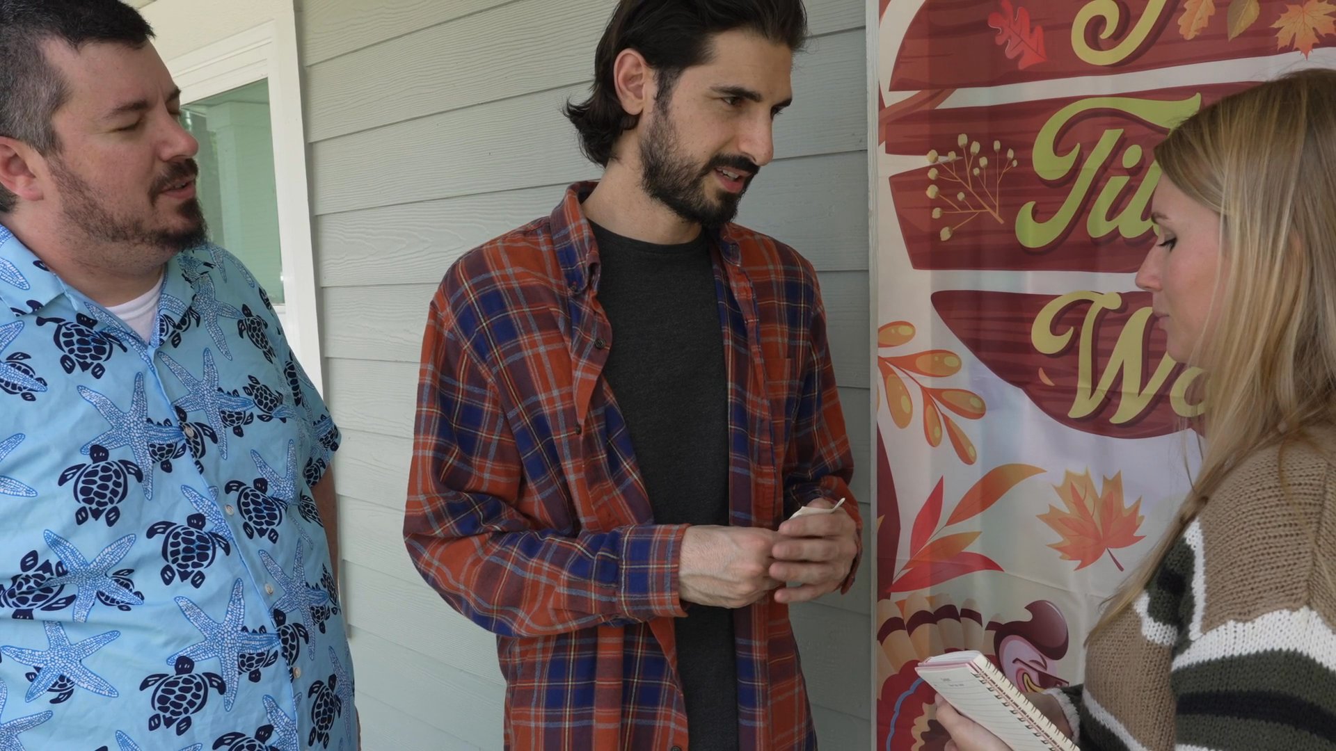 Three individuals engage in a collaborative dialogue, exchanging ideas and coordinating project details in an outdoor setting.