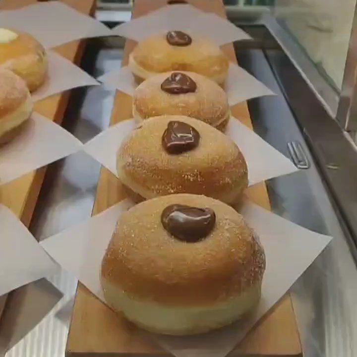 Ace Coffee Roasters - Donut display case featuring Nutella, custard, apple, apricot filled, brown butter and chocolate donuts - Coffee Roasteries Near Me - Edmonton, Alberta