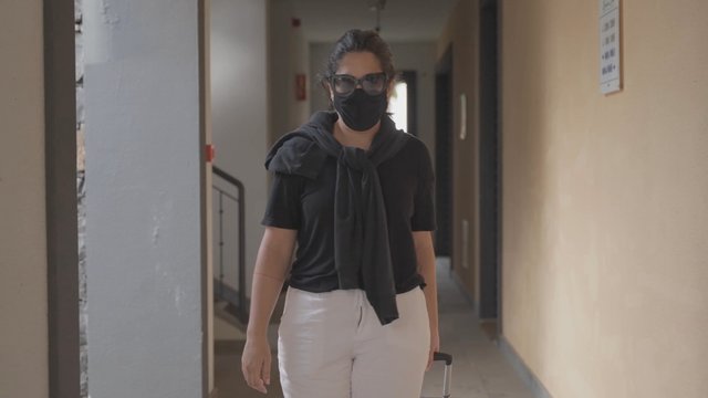 Medium shot of a tourist walking to a hotel room