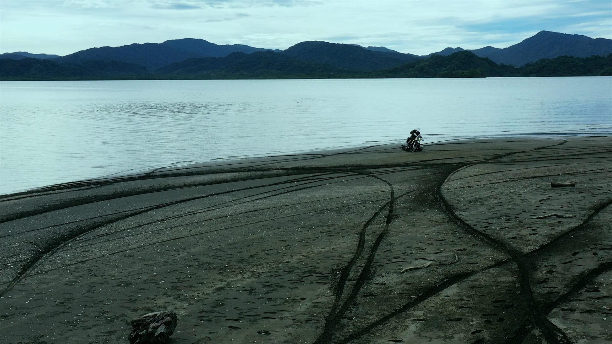 Man riding motorcycle on beach in Costa Rica