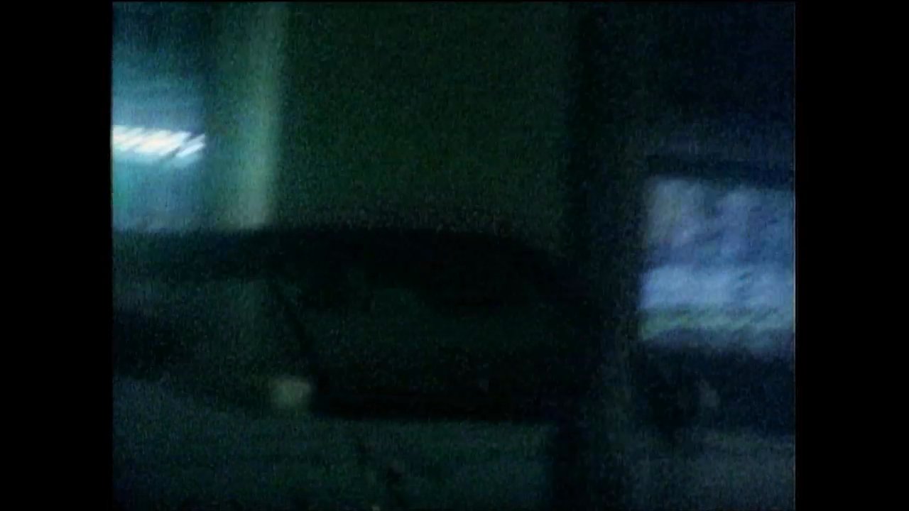 A group of friends engages in conversation on a rooftop overlooking an urban vista at night. The sequence transitions from this social setting to various exterior shots highlighting neon signage and palm trees silhouetted against the dark sky.