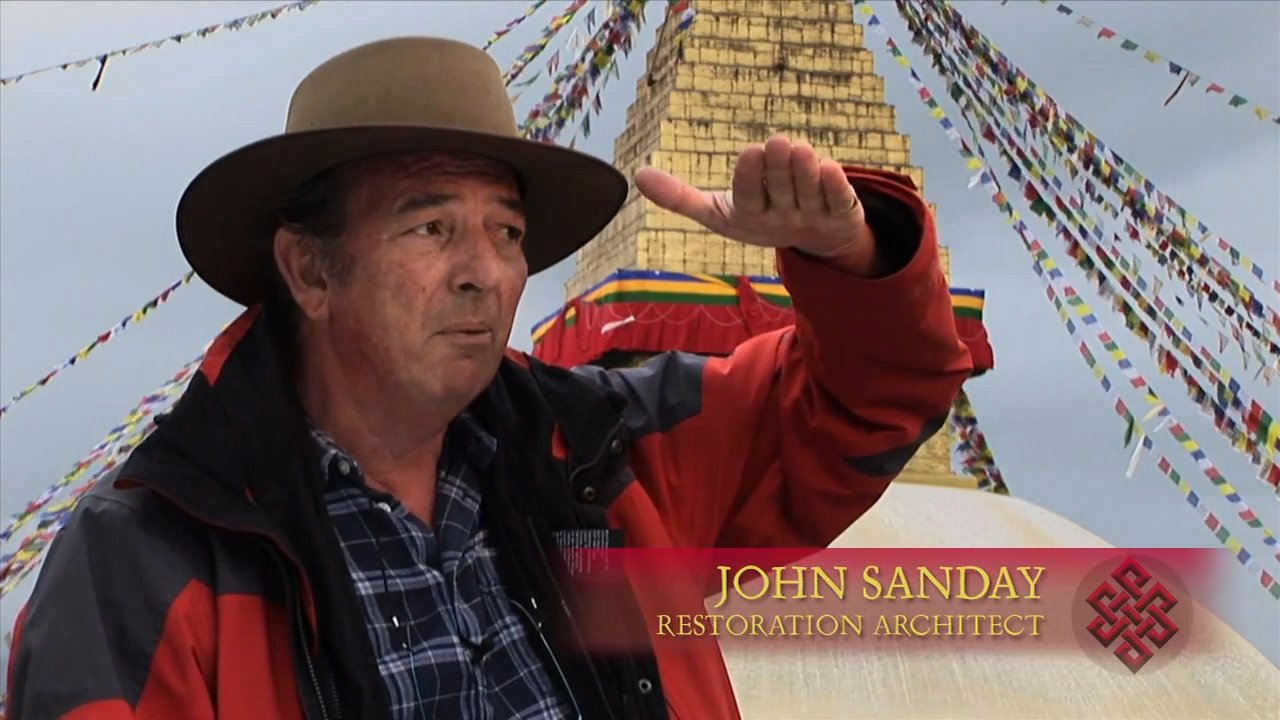 Restoration architect John Sanday inspects ancient murals and structural elements within a Himalayan monument. The assessment involves evaluating the preservation status of historical religious imagery and supervising site excavation works.