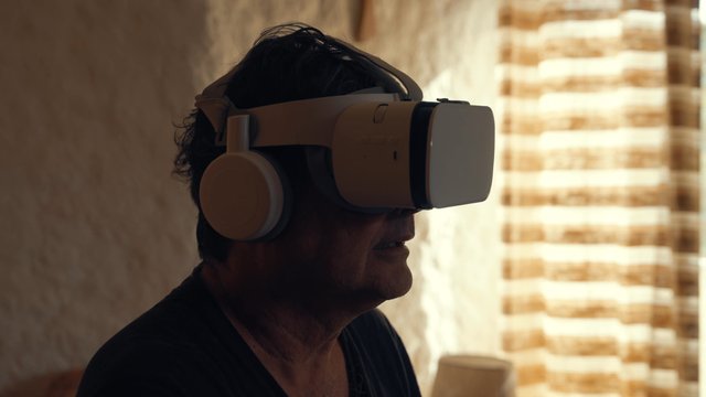 An adult man using his VR headset