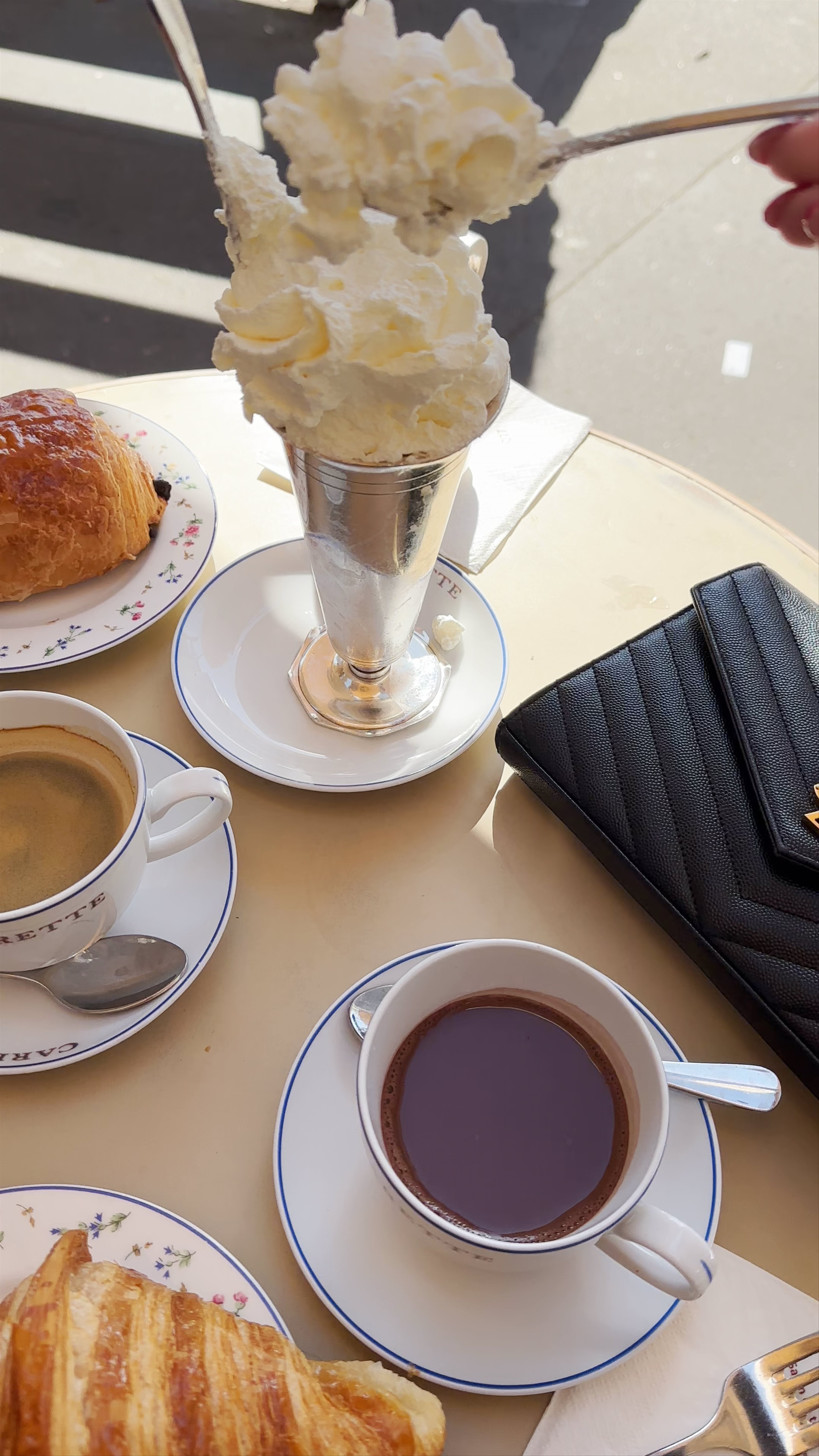 Charming Parisian Café Moment: Hot Chocolate with Whipped Cream & Croissants