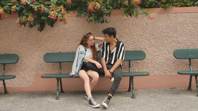Happy couple sitting on a bench