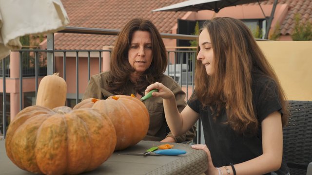 Carving a pumpkin outdoors