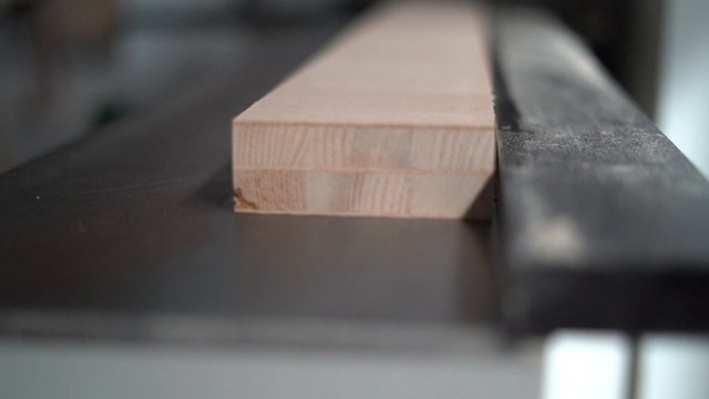 Wood entering a factory machine 