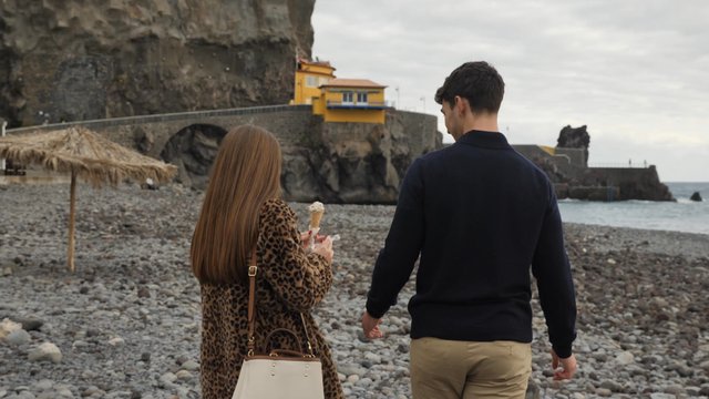 Couple walking and eating ice cream