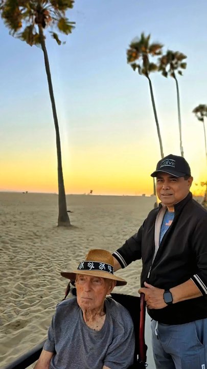 Home Instead - Noelle walking Matt along Newport Beach promenade - Home Health Care Near Me - Downey, California
