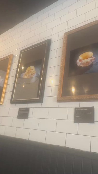Smashed - Burgers from the menu displayed on the wall like a pice of art in a museum - Burgers Near Me - New York, New York
