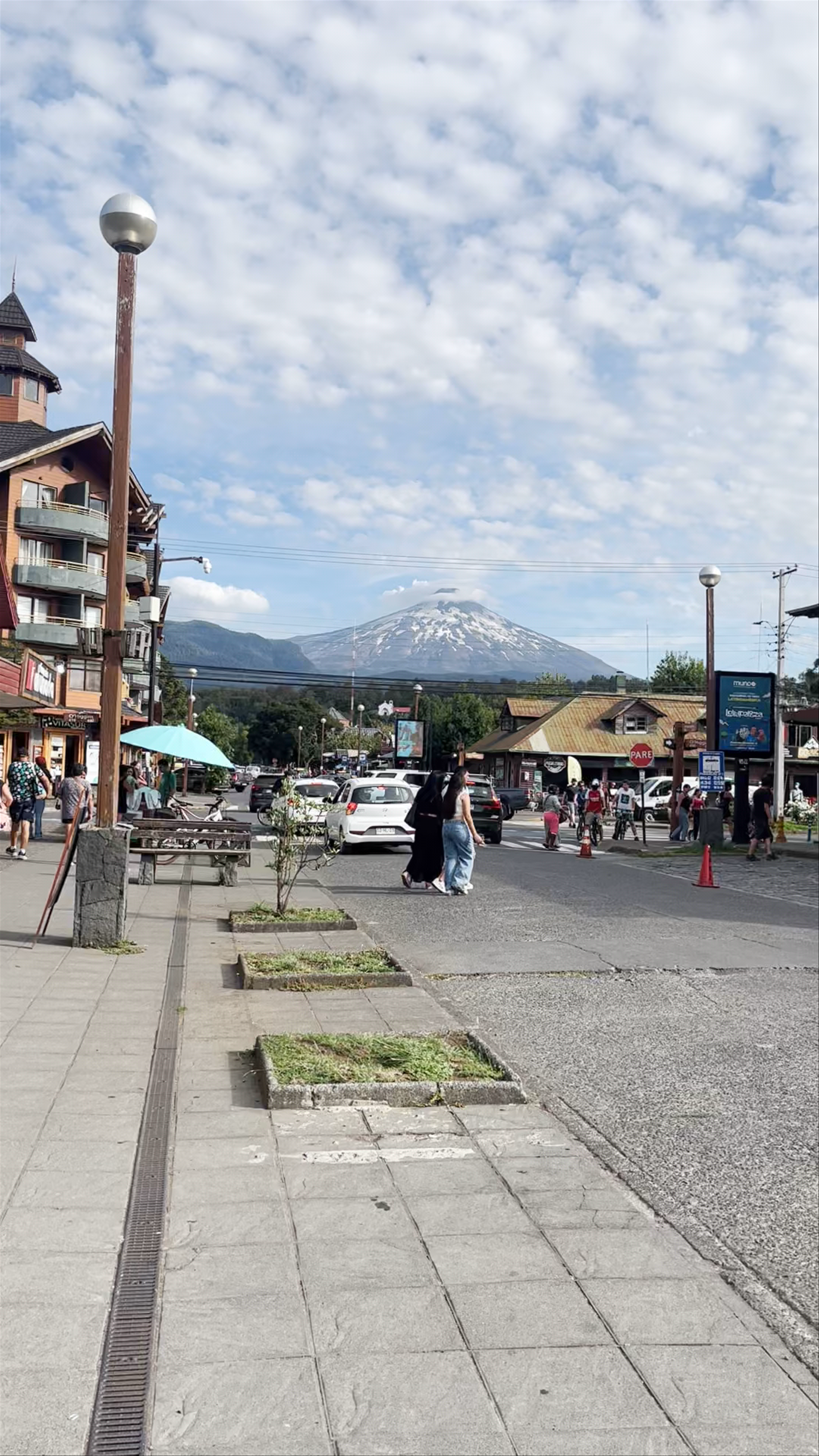 Sunlit Streets of Pucón with Majestic Villarrica Volcano