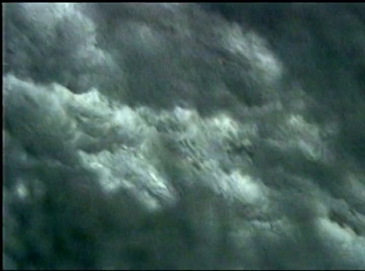 Experienced surfers navigate challenging ocean waves while industry figures provide commentary on the sport in interview settings. The footage documents both technical surfing maneuvers and the cultural history of the discipline.