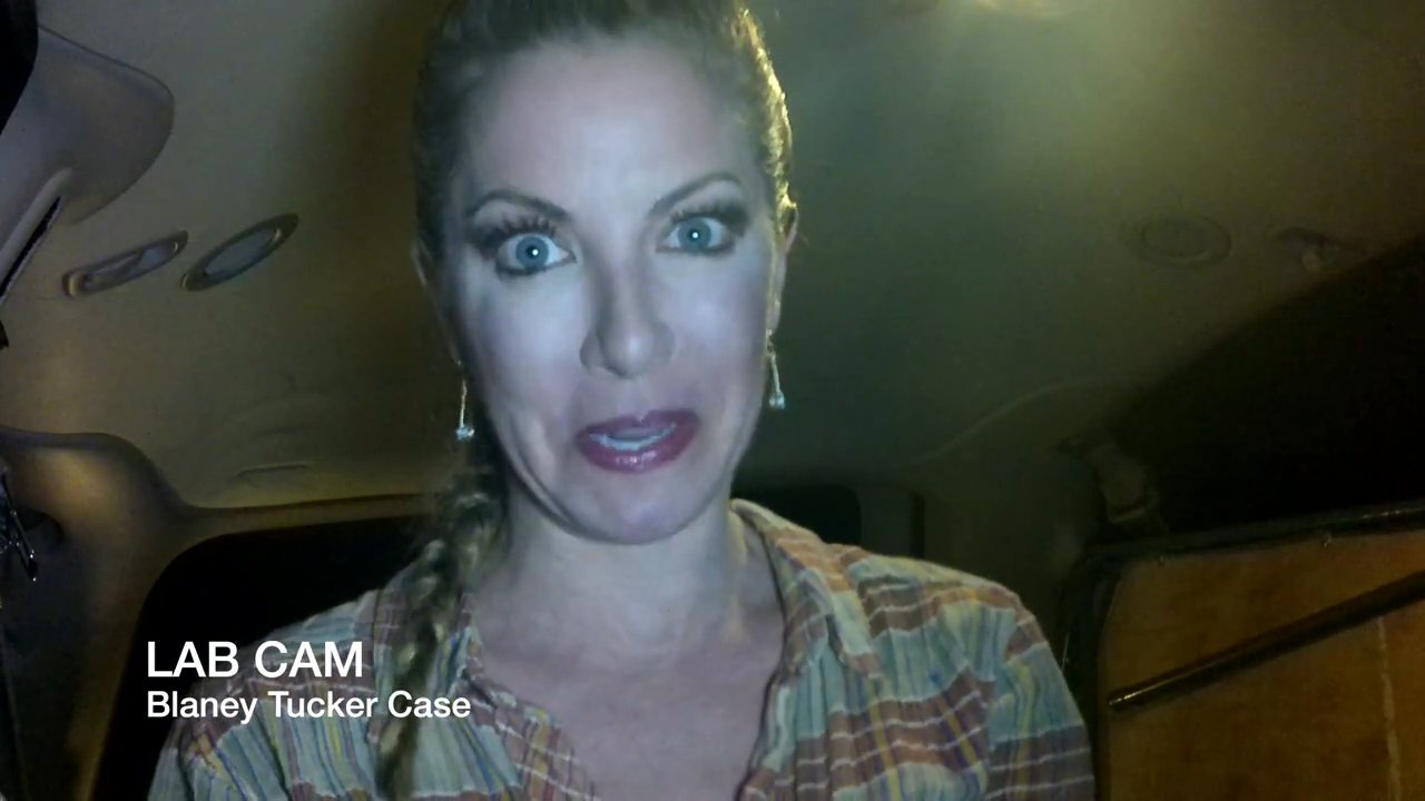 A woman delivers a piece-to-camera testimony inside a vehicle before transitioning to a night vision perspective of a cemetery grave marker.