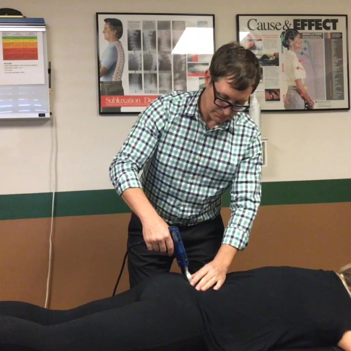 ​Daniel Weisbecker, DC - Dr Weisbecker using an impulse adjuster. - Chiropractors Near Me - Waipahu, Hawaii